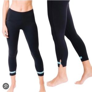 Zyia Active leggings. Navy blue with aqua straps at bottom. Size 6-8.
